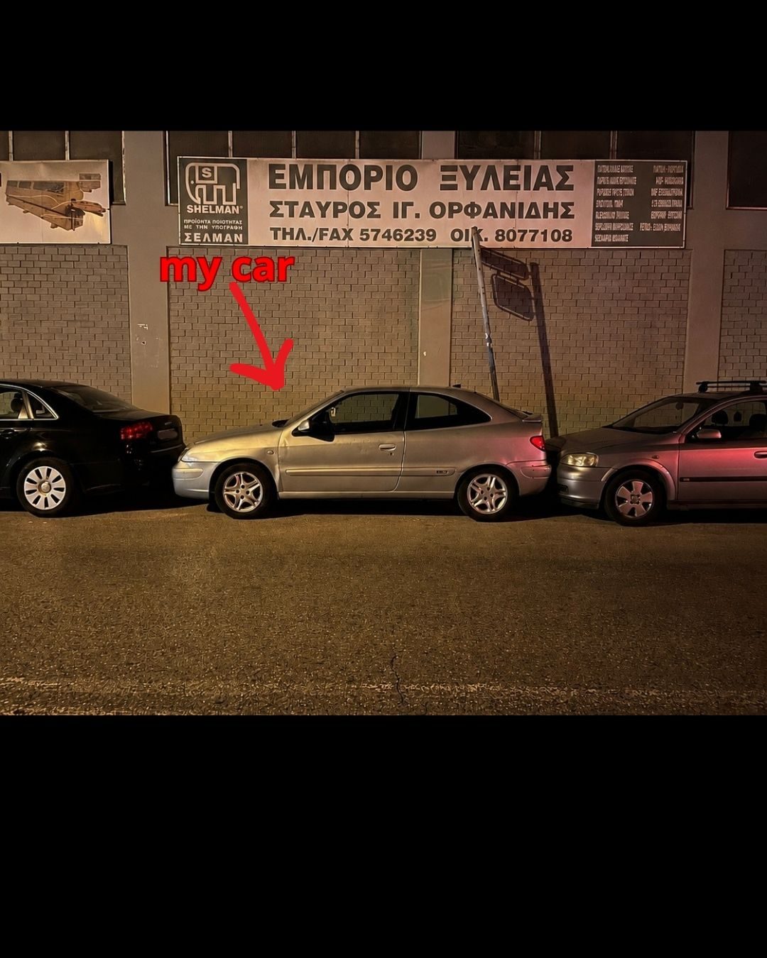 Two cars block Konstantinos’s car, one in front and one behind.